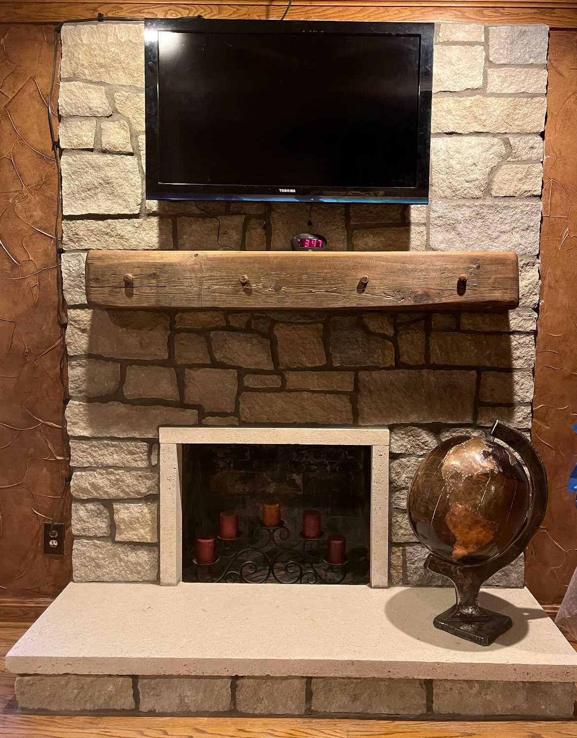 stone fireplace with wood mantel